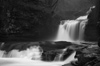 B&W photograph of waterfall showing slow shutter speed motion blur