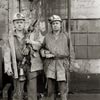 photograph of miners after cleaning pit head shaft with safety gear and equipment